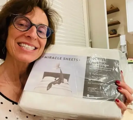 Dana b from Wyoming holding Miracle Made Sheets and smiling after receiving her order